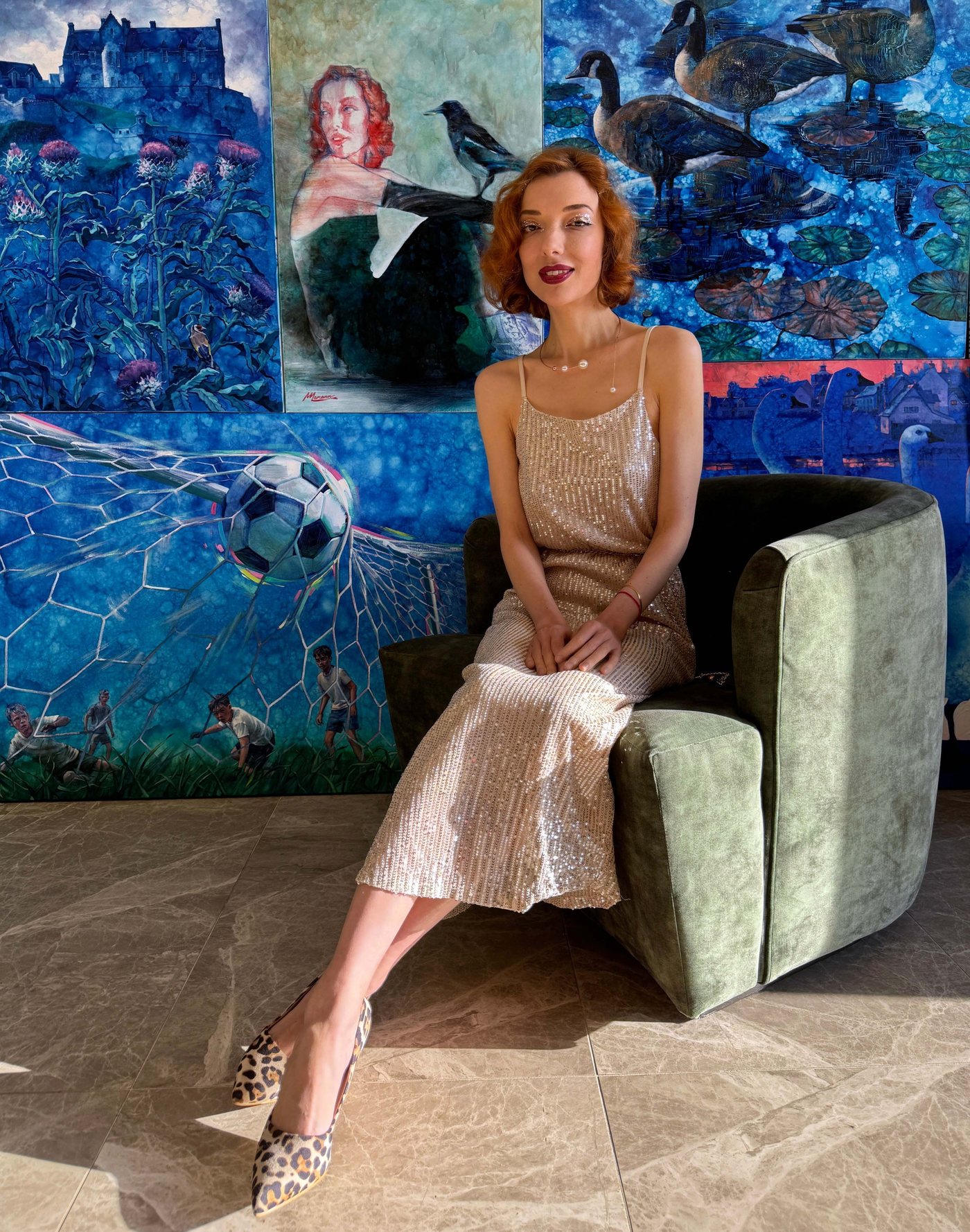Margarita Lemann in the studio, seated in front of her paintings